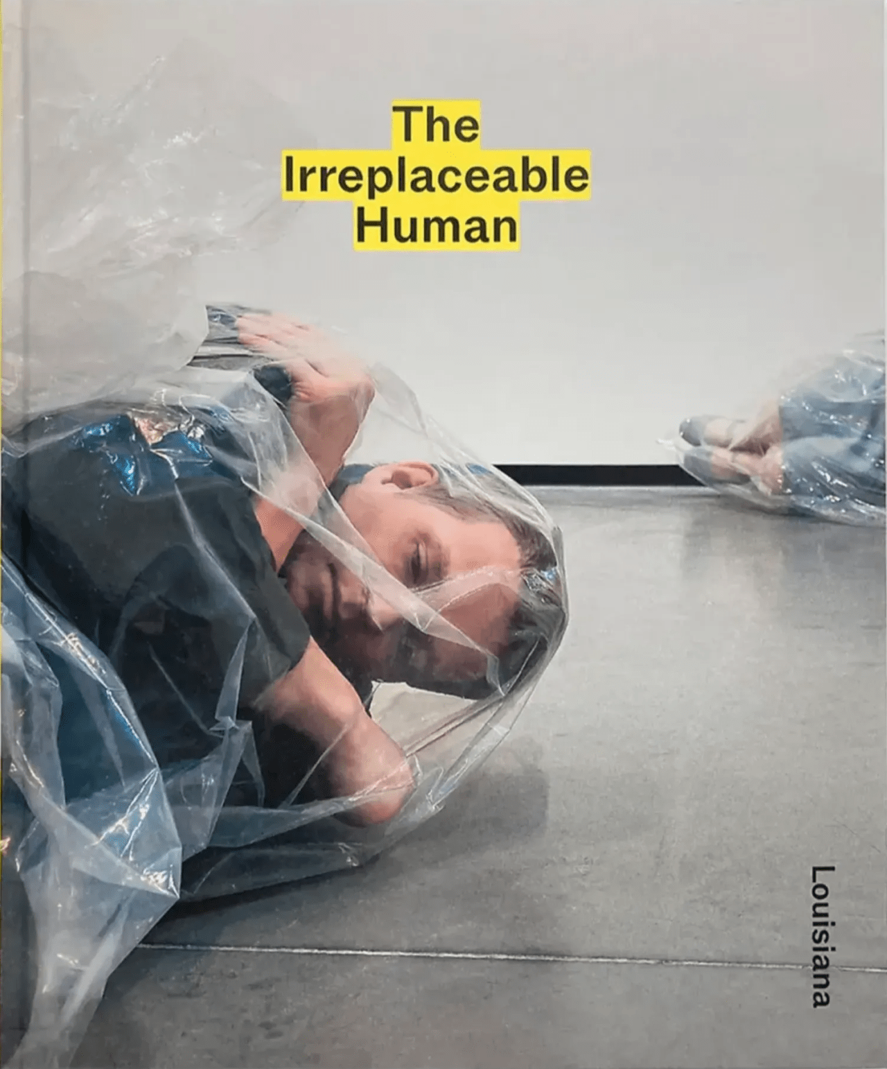 Man and woman on the floor wrapped in plastic
